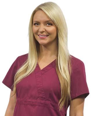 Blonde woman in wine colored scrubs