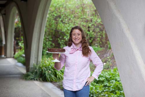 Smiling woman holding a cake