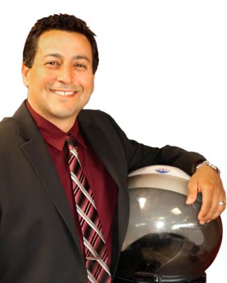 Smiling man in suit and tie, arm slung over space helmet
