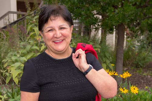 Smiling woman standing outside Emeritus building