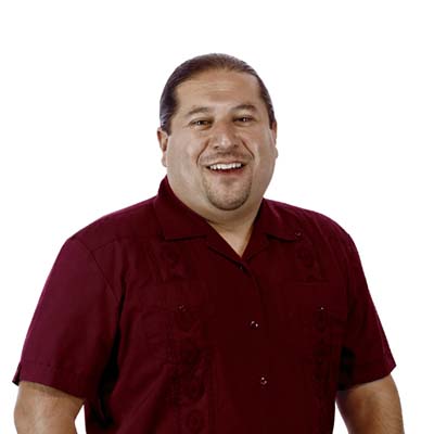 Smiling man in a maroon shirt, against a white background