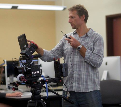 Man operating digital video camera