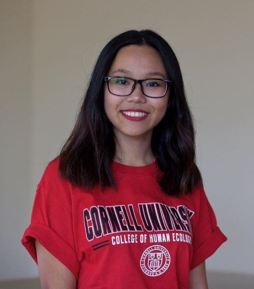 Head and shoulders portrait of woman in red Cornell University tee shirt